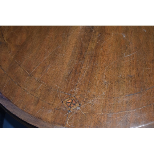 521 - Victorian quarter veneered burr walnut oval table with ornately carved legs on casters, satinwood in... 