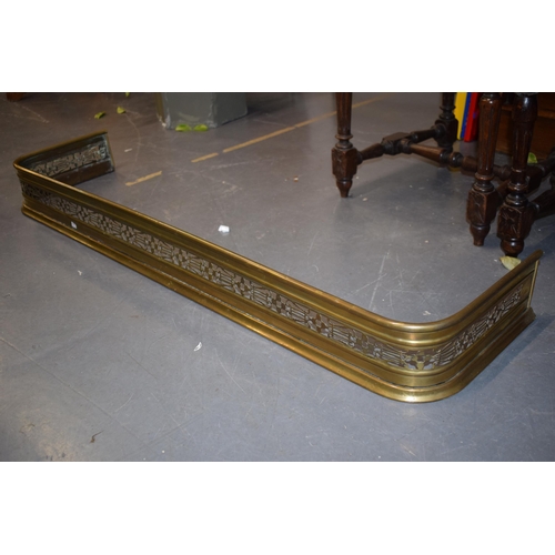 539 - Antique brass fire fender / surround with fretwork design. 124cm x 32cm.