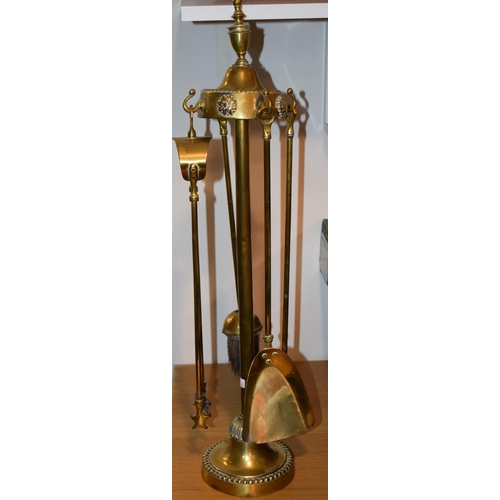 540 - Victorian brass fire-side companion set with four original attachments. Height 62cm.