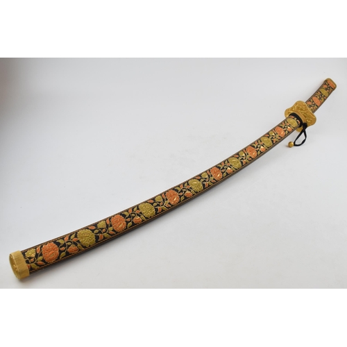 556 - A vintage decorative Samurai sword in embroidered sheath, engraved blade and brass hilt. Length 96cm... 