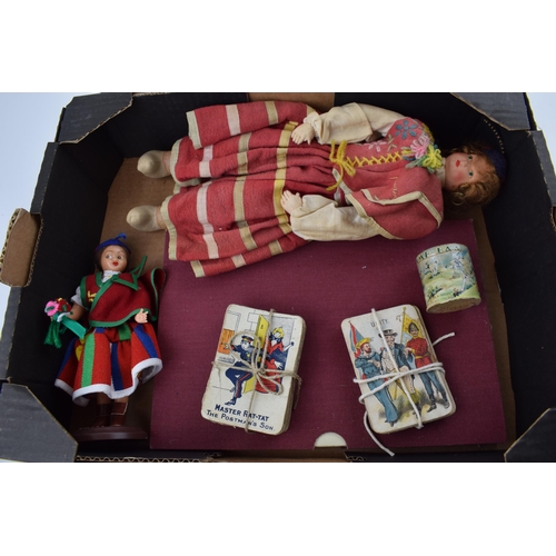 696 - A collection of vintage toy items to include two Madeira dolls, two early packs of pictorial playing... 