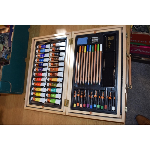 404 - A collection of artist's equipment and materials to include NOS paints and brushes, watercolour pads... 