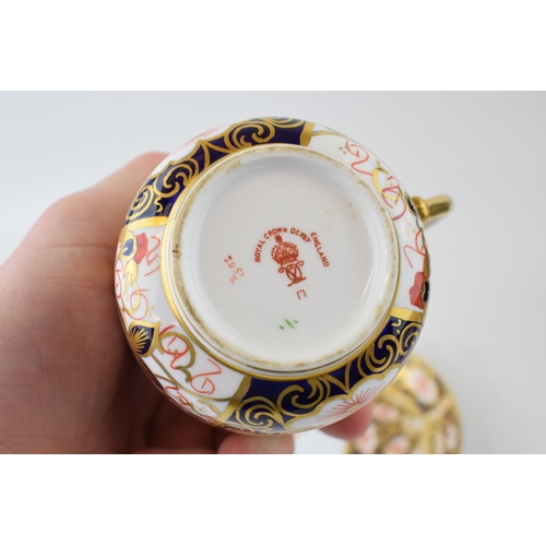 31 - An Edwardian Royal Crown Derby bone china moustache cup and saucer in Imari pattern (2).