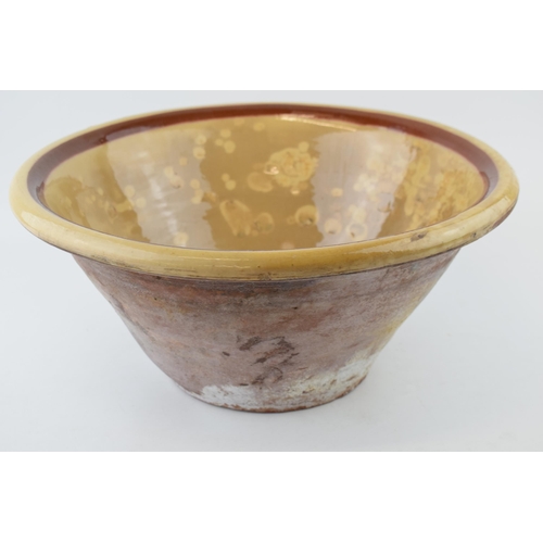 287 - An antique English dairy bowl with cream / brown salt glaze. Diameter 40cm. Height 19cm.