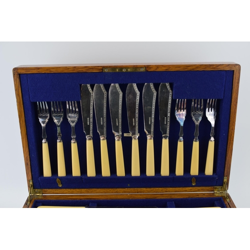 292 - A silver-plated cutlery service in a golden oak canteen by George Butler & Co Sheffield. Escutcheon ... 