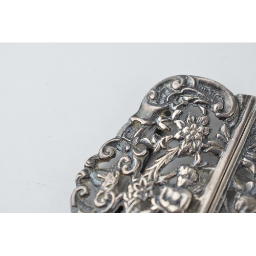 296 - Hallmarked silver ornate nurse's belt buckle with putti decoration, 33.6 grams, 6cm wide.