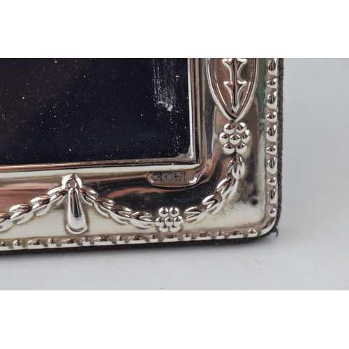 300 - Silver ornate photo frame with ribbon and bow decoration, 24.5cm tall, easel-back, Sheffield 1996.