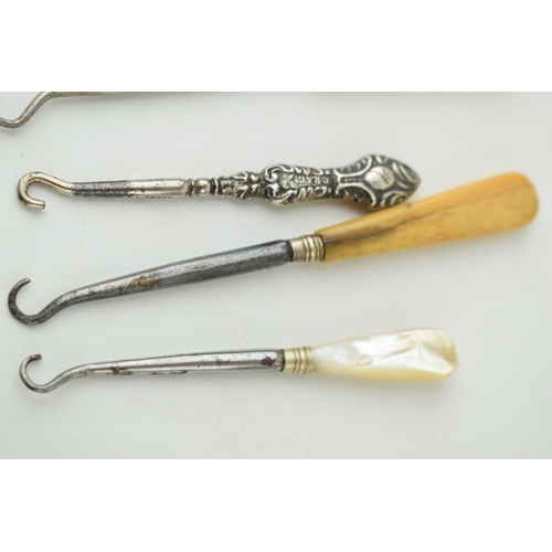 316 - A collection of vintage button hooks to include a silver handled example, 2 bone handled items, a mo... 