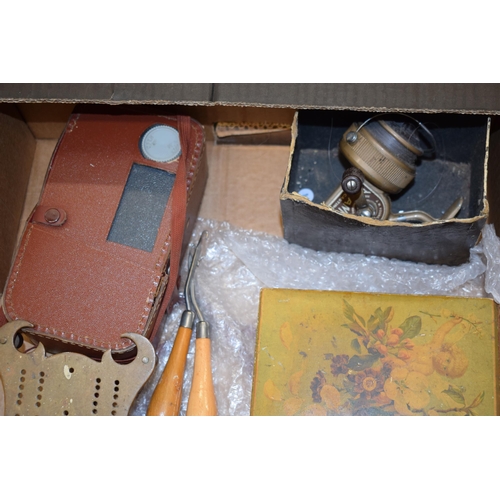 325 - A mixed collection of items to include two WWII era gas masks, a scratch built brass cribbage board,... 