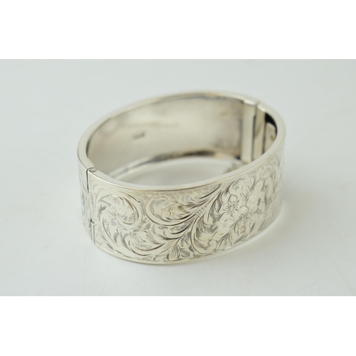 330 - Hallmarked silver wide bangle, Birmingham 1937, 30.0 grams, with engraved floral decoration, 25mm wi... 