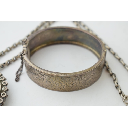 336 - A collection of Victorian silver items to include a bangle a locket with bird motif on chain and a r... 