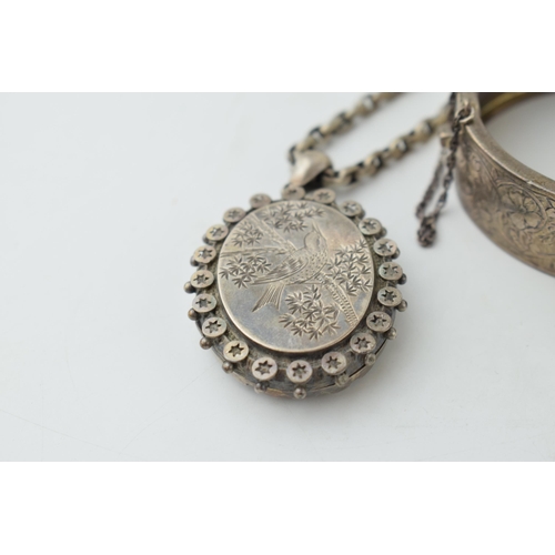 336 - A collection of Victorian silver items to include a bangle a locket with bird motif on chain and a r... 