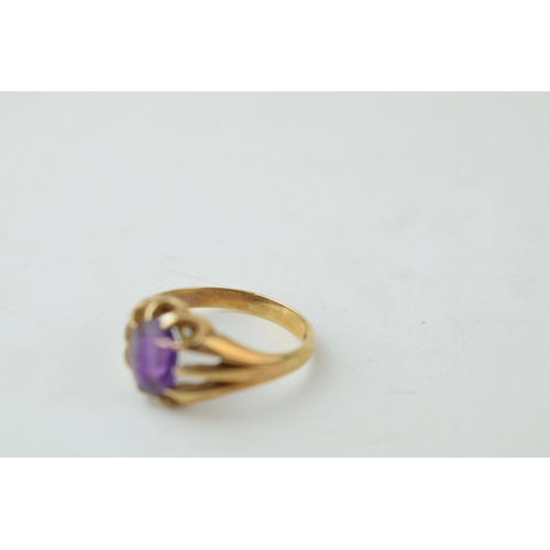 339 - A gentleman's ring set with purple stone. Ring size Q. Gross weight 3.8 grams.