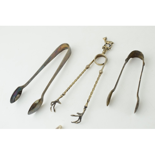 342 - A continental 800 silver pair of sugar claws with goat finial, 18.2 grams, a pair of silver sugar ni... 