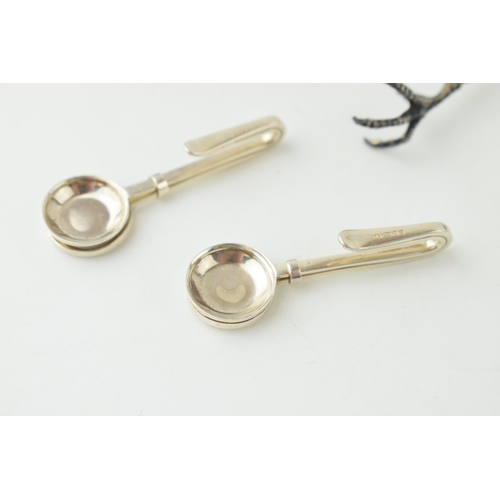 342 - A continental 800 silver pair of sugar claws with goat finial, 18.2 grams, a pair of silver sugar ni... 