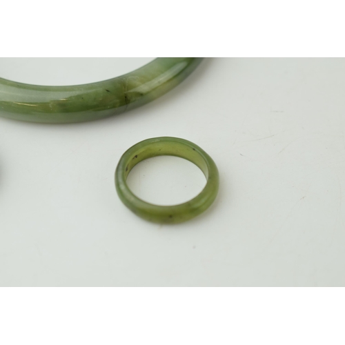 343 - Two jade rings sizes O and P together with a jade bangle. (3) Weight 42.8 grams.