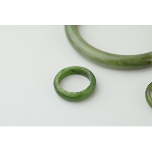 343 - Two jade rings sizes O and P together with a jade bangle. (3) Weight 42.8 grams.