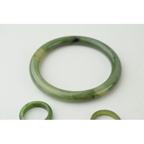 343 - Two jade rings sizes O and P together with a jade bangle. (3) Weight 42.8 grams.