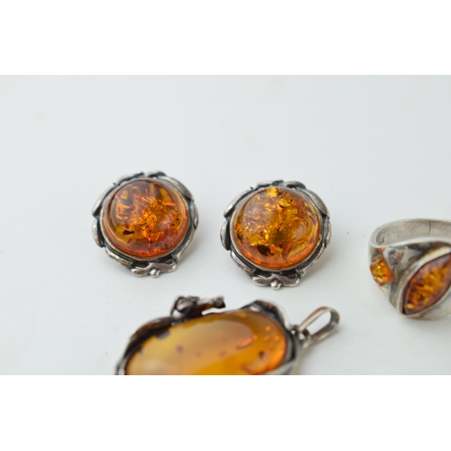 350 - A collection of silver mounted amber jewellery to include a pendant, with another floral mounted exa... 