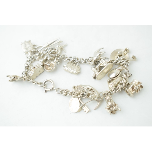 370 - Silver charm bracelet with circa 19 charms to include scissors, a turtle, a toby jug and others, 46.... 