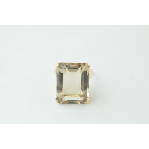 372 - 9ct gold dress ring with smokey coloured stone, emerald cut, gross weight 7.1 grams, size R.