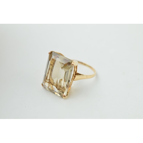 372 - 9ct gold dress ring with smokey coloured stone, emerald cut, gross weight 7.1 grams, size R.