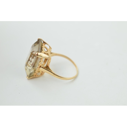 372 - 9ct gold dress ring with smokey coloured stone, emerald cut, gross weight 7.1 grams, size R.