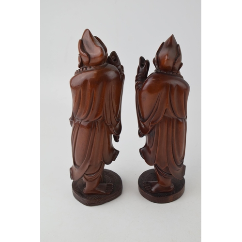 395 - A pair of oriental smiling figures, wooden, 22.5cm tall (2).