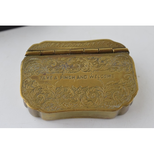 396 - A pair of vintage snuff boxes to include a brass engraved example 'take a pinch and welcome' with an... 