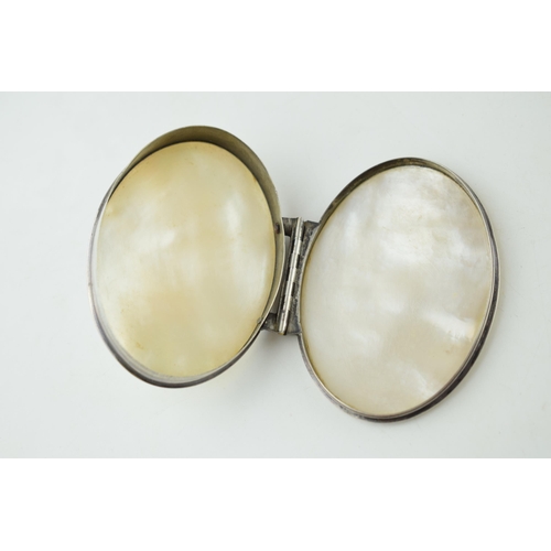 404 - A Georgian or later silver and mother of pearl oval hinged box, 8cm diameter.