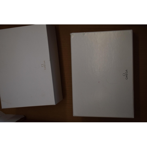 446 - A collection of original Omega outer white boxes. (9)