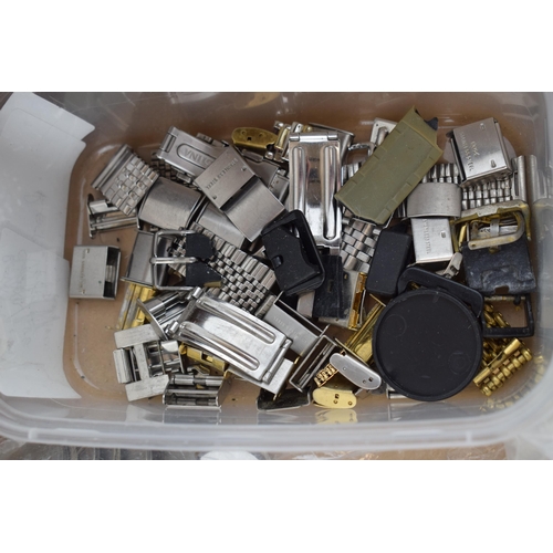 447 - A large collection of watch parts to include bezels, quartz movements, watch backs and links.