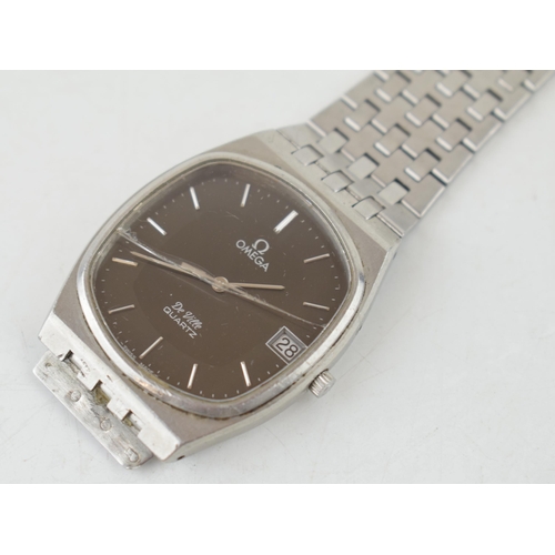 460 - An Omega De Ville Quartz gentleman's wristwatch. Oval black / grey dial with date window at 3pm. Ori... 