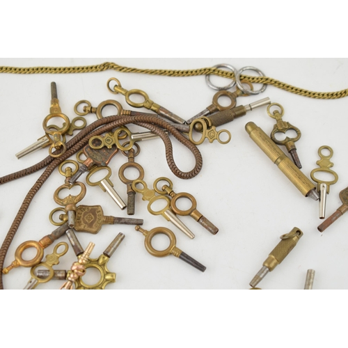 462 - A collection of antique watch keys and brass chains together with a Breitling watch crown. (Qty)