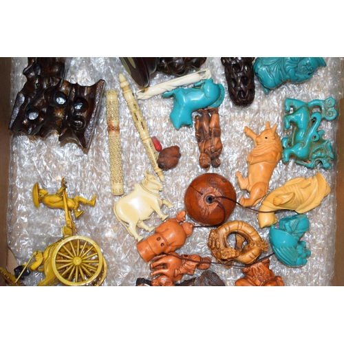 536 - A collection of carved miniature oriental items to include netsukes and miniature figures in wood, b... 