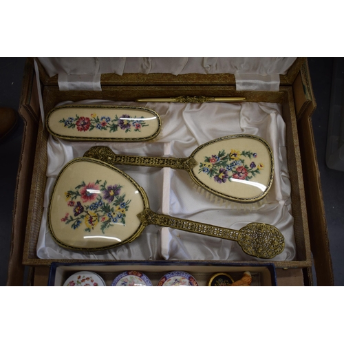 616 - A boxed vintage dressing table set together with a collection of enamel pill boxes, a silver pill bo... 