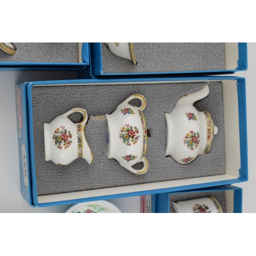 116 - A collection of Coalport pottery miniatures in the Ming Rose pattern to include boxed examples of cu... 