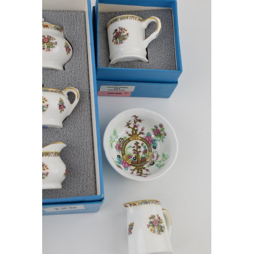 116 - A collection of Coalport pottery miniatures in the Ming Rose pattern to include boxed examples of cu... 