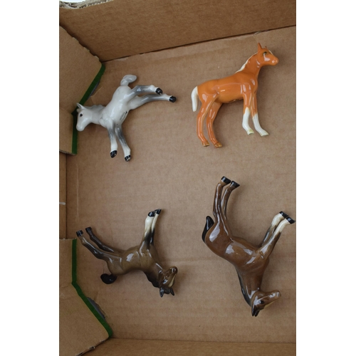 173 - A collection of Beswick foals to include brown, grey and palomino colourways with a Beswick point of... 