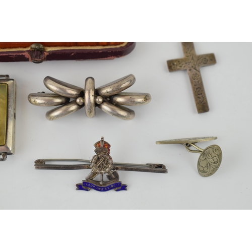 318 - A collection of silver items to include watch case, cross on chain, brooch and other similar items.