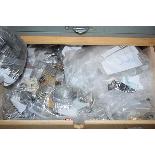 479 - Two sets of drawers containing watch and lock parts to include NOS watch straps and bracelets, ceram... 