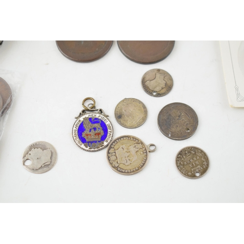 485 - A collection of pre-1920 defaced silver coins, circa 25 grams, to include enamelled coins and mounte... 