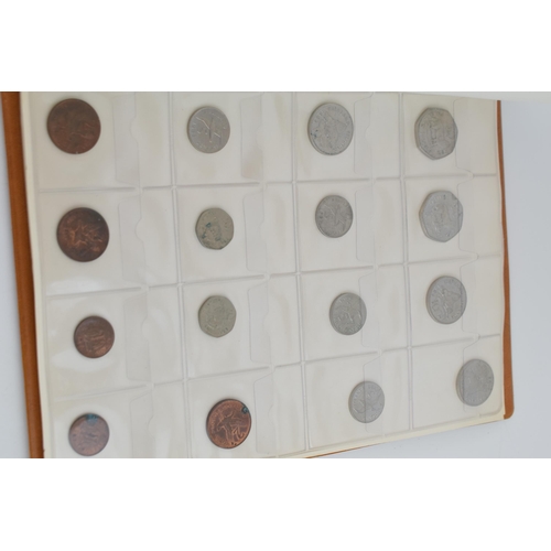 487 - A collection of UK and foreign coinage housed in a collectors folder. Of note a 1921 silver Dollar, ... 