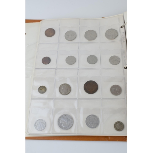 487 - A collection of UK and foreign coinage housed in a collectors folder. Of note a 1921 silver Dollar, ... 