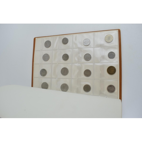 487 - A collection of UK and foreign coinage housed in a collectors folder. Of note a 1921 silver Dollar, ... 