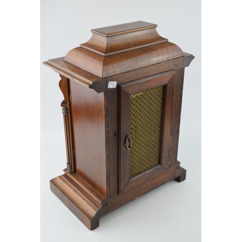 550 - A mantle clock with chiming movement, Roman numerals to dial, wooden case. Key and pendulum present.... 