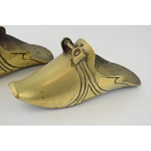 560 - A pair of chinese style brass stirrups. Length 29cm, height 12cm.