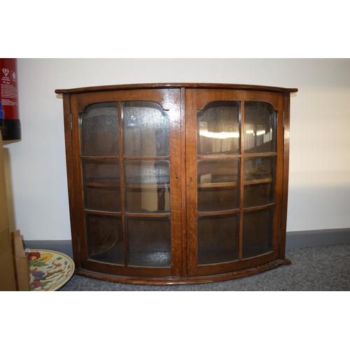 578 - An early to mid 20th century oak bow fronted display cabinet 75cm wide, 59cm tall.