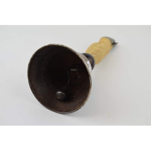 583 - An antique bell with taxidermy deer's hoof handle set in ebonized turned mount. Height 20cm.