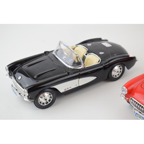 595 - Two Burago 1/18 scale Chevrolet Corvette (1957) one in red and one in black. (2)